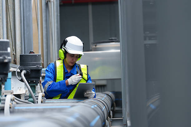 istock Engineer under checking the industry cooling tower air conditioner is water cooling tower air chiller HVAC of large industrial building to control air system 2241418526