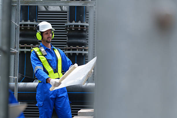 istock Engineer under checking the industry cooling tower air conditioner is water cooling tower air chiller HVAC of large industrial building to control air system 2241418540