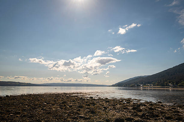 A sunny autumnal HDR image of an empty Ardentinny beach in Finart Bay near Dunoon, Argyll and Bute, Scotland.