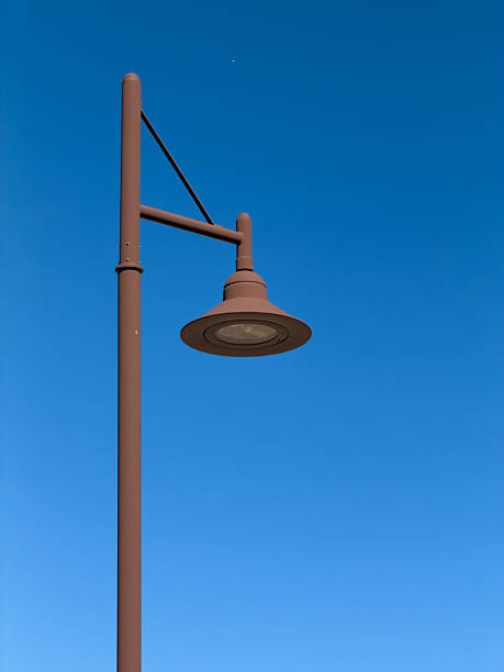 istock Brown lamppost illuminating against clear blue sky 2241420226