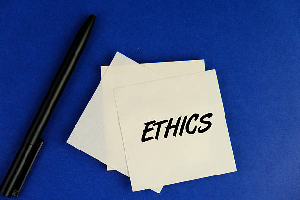 Ethics words on the white notepad with letters, ethics moral philosophy concept, business and management concept. blue background.