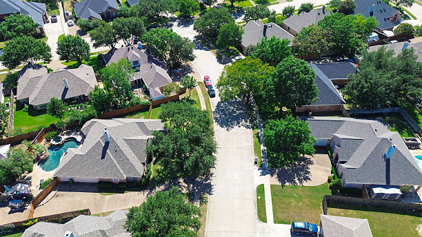 istock Aerial close-up view upscale two-story homes shingle roofs, spacious lots, backyard pools, and mature trees in North Richland Hills, Texas. Showcase of suburban luxury, green recreational living 2241421806