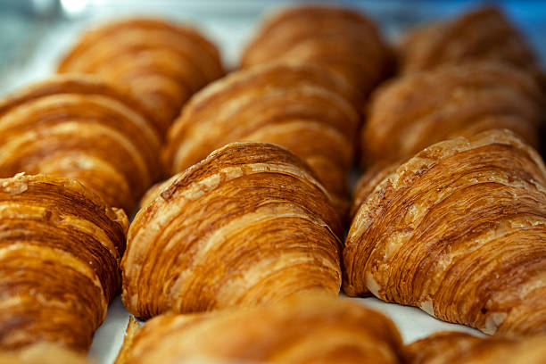 istock Freshly baked croissants in bakery display 2241424892