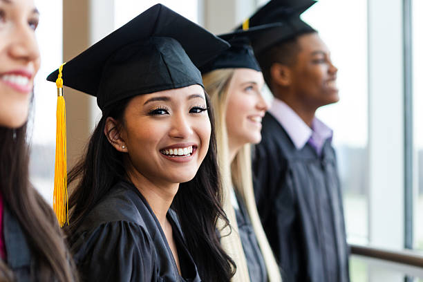 istock Graduates in caps and gowns celebrating success and a bright future 2241429139