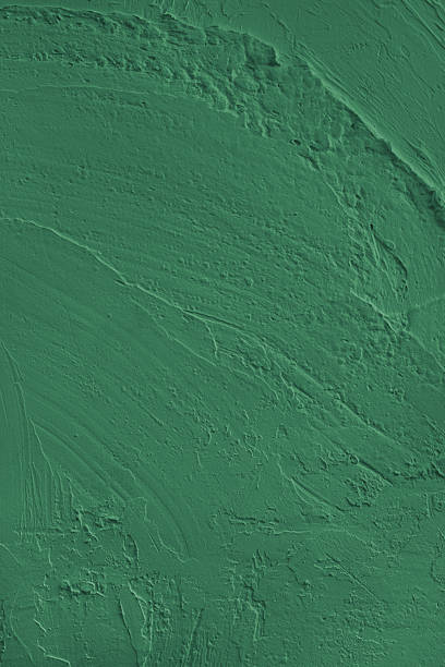 istock Textured green cement wall surface, rough texture with strokes for design and background 2241429619