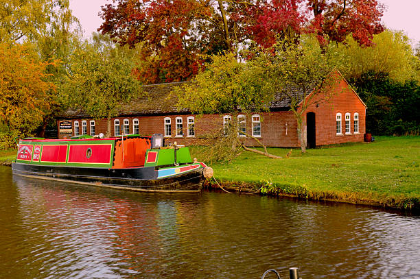 Two canal barges moored up for the day on the grand union canal in Northamptonshire uk.