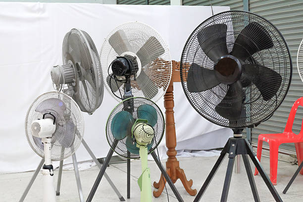 Metal fan blowing cold air in storage shed.