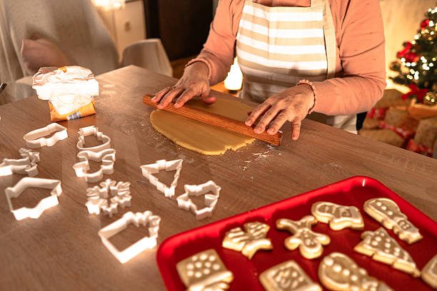 Woman kneads the dough. She making Christmas cookies at home. Close up of hands.