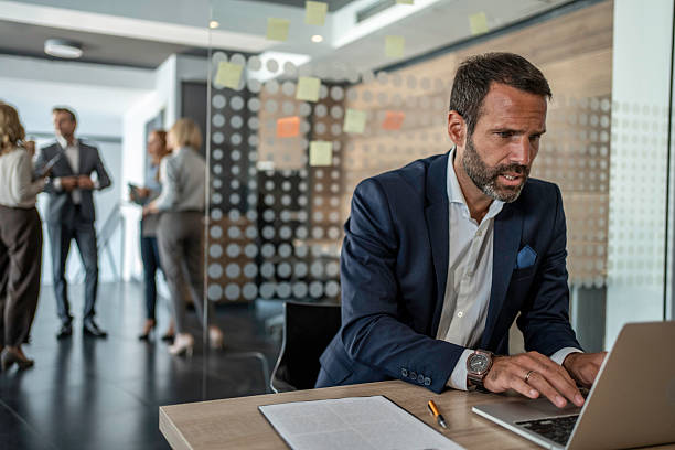 istock Businessman working on laptop in modern office 2241432994