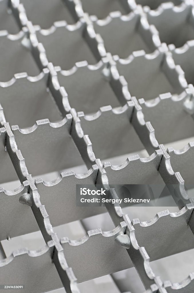 Openwork serrated metal lattice with square cells Openwork serrated metal lattice with square cells, close-up shot, abstract background Abstract Stock Photo Openwork serrated metal lattice with square cells Openwork serrated metal lattice with square cells, close-up shot, abstract background Abstract Stock Photo