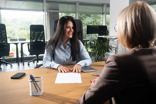 istock Female financial advisor checking financial forms in modern workspace 2241434988