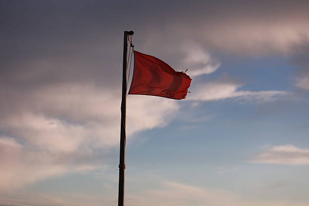 istock Red flag is flying in the sky 2241435659