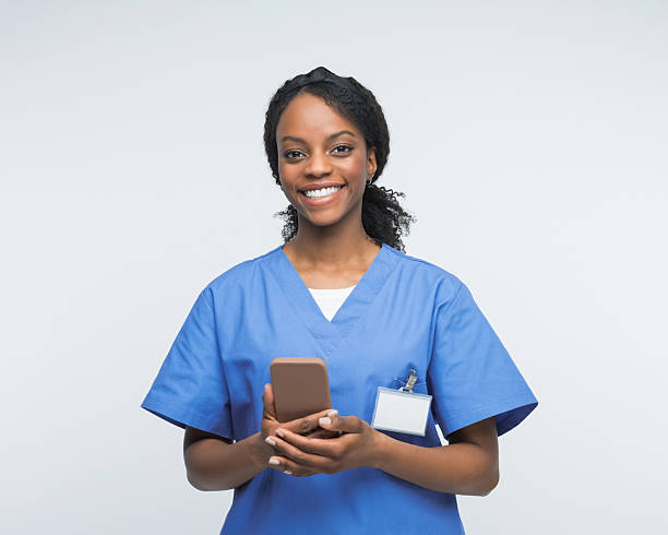 istock Portrait of friendly nurse using smart phone 2241437072