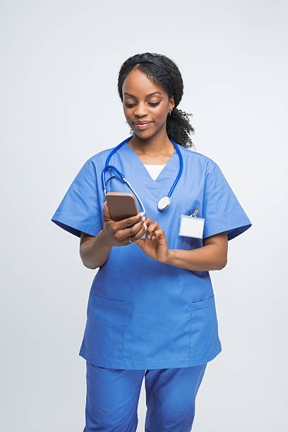 istock Portrait of friendly nurse using smart phone 2241437366