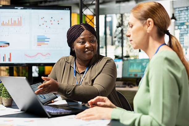 istock Diverse business partners gather around the table in corporate office 2241437711