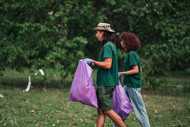 istock Volunteers cleaning park, collecting plastic garbage 2241441146