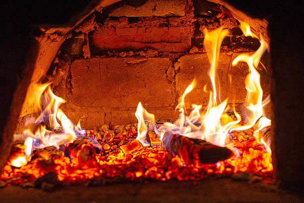 istock Traditional brick oven with burning firewood for baking bread 2241441253