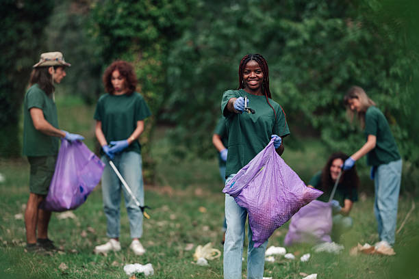 istock Volunteers cleaning park, helping environment, smiling at camera 2241441341