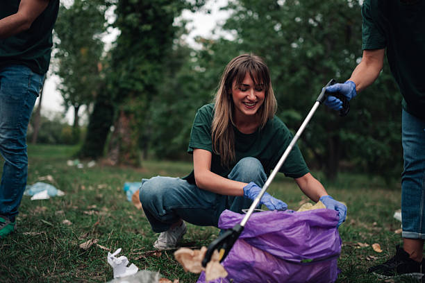 istock Volunteers cleaning park, picking up trash for environment protection 2241442267