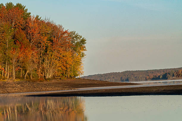 Fall foliage colors the landscape on a frosty autumn morning at the Salmon River Reservoir, aka Redfield Reservoir in Redfield, NY.