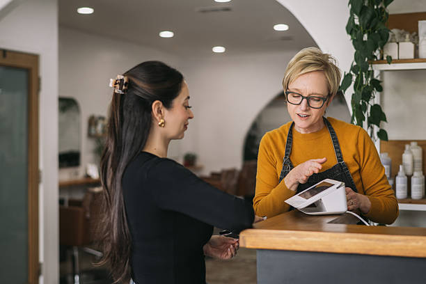 istock Female Salon Owner Ringing up a Female Customer 2241450604
