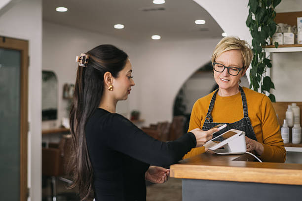 istock Female Salon Owner Ringing up a Female Customer 2241450657