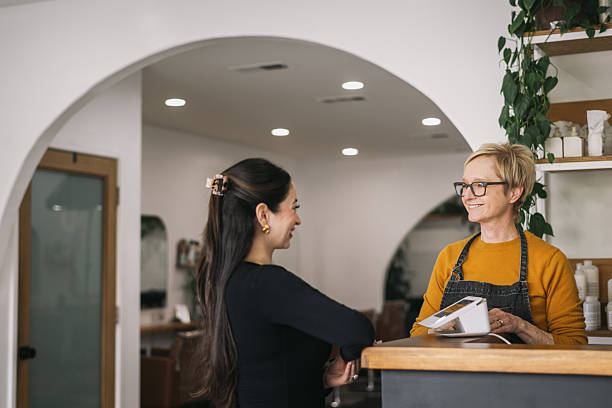 istock Female Salon Owner Ringing up a Female Customer 2241450695