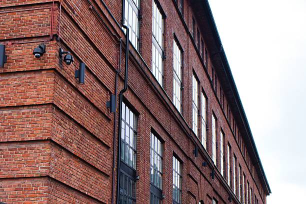 istock Weathered brick industrial building with large windows 2241450715