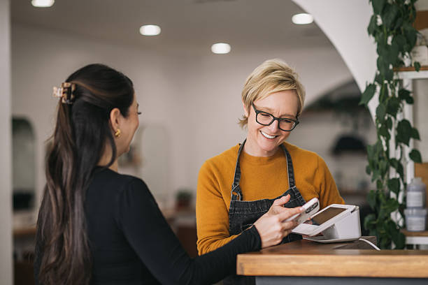 istock Female Salon Owner Ringing up a Female Customer 2241450840