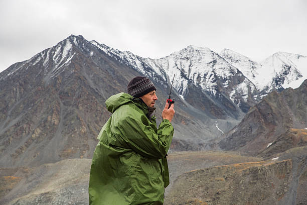 istock A man in the mountains talks on a walkie-talkie 2241451112