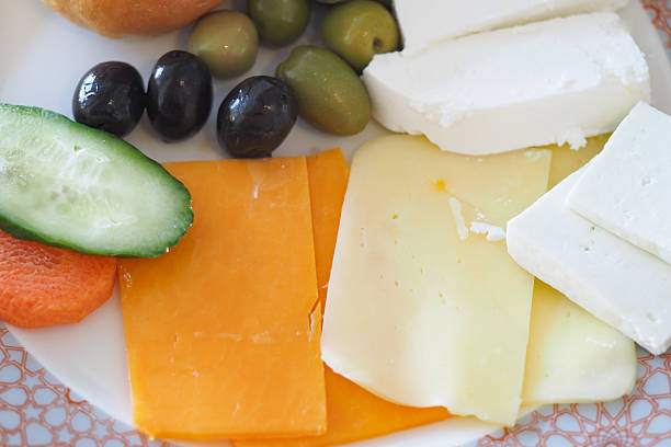 istock Delicious assortment of cheese and vegetables on a plate 2241454911