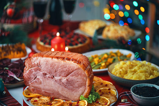 istock Christmas Dinner with Baked Glazed Ham and Various Vegetables 2241455438