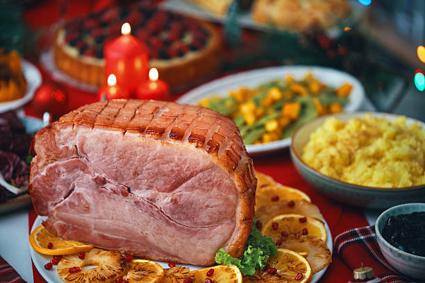 istock Christmas Dinner with Baked Glazed Ham and Various Vegetables 2241455457