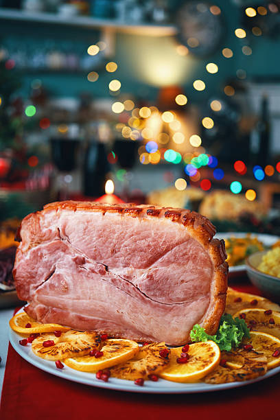 istock Christmas Dinner with Baked Glazed Ham and Various Vegetables 2241455542