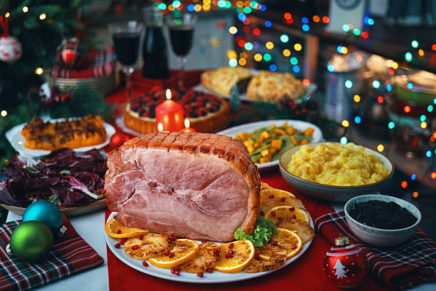 istock Christmas Dinner with Baked Glazed Ham and Various Vegetables 2241455545