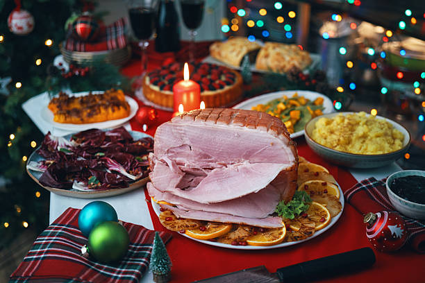 istock Christmas Dinner with Baked Glazed Ham and Various Vegetables 2241455872
