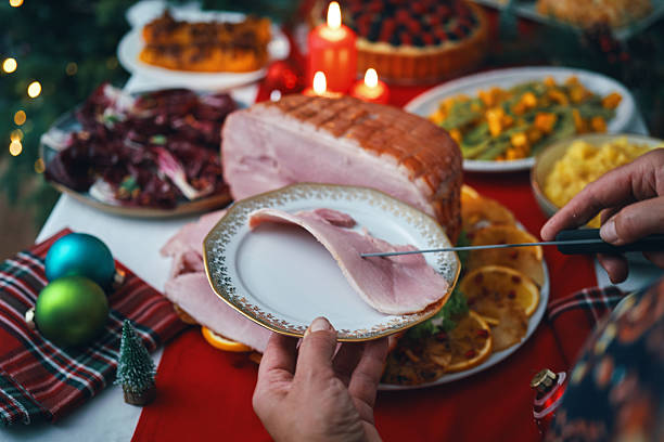istock Christmas Dinner with Baked Glazed Ham and Various Vegetables 2241455880