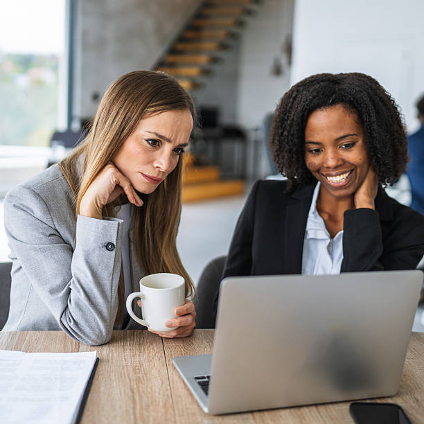 istock Businesswomen collaborating on laptop showing different emotions 2241456638