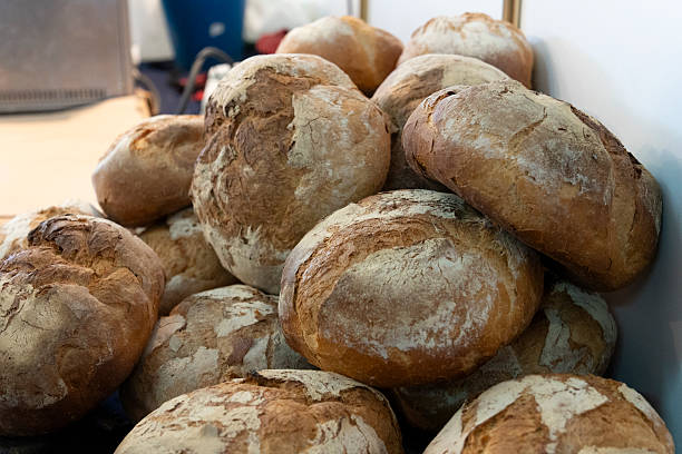 istock A rustic bakery display showcasing freshly baked artisanal loaves, each with a unique texture and crust. 2241458344