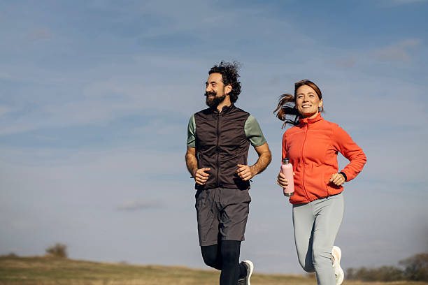 istock Couple jogging together outdoors on sunny day 2241458680