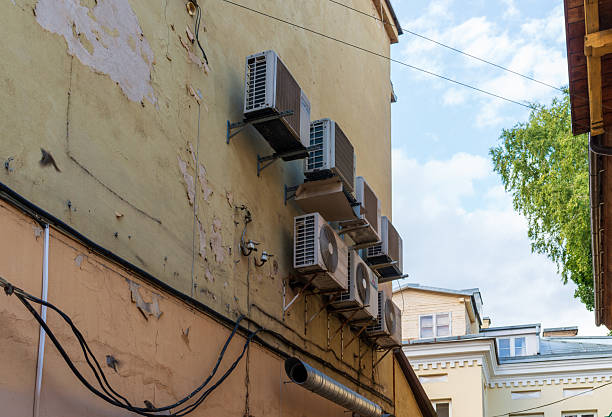 istock Air conditioning units mounted on old urban wall 2241459931