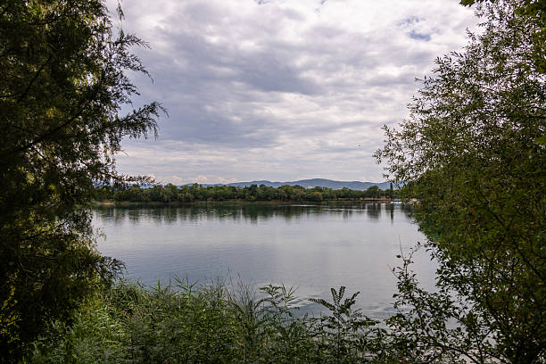 istock Peaceful Lake with Reflections and Green Trees 2241460610