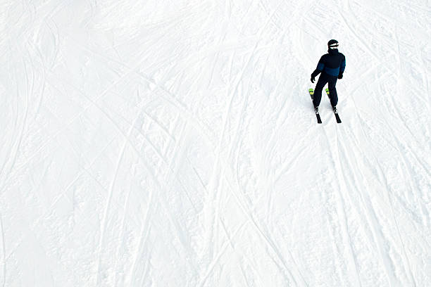Top View of White Sunny Snow Tracks and Skier