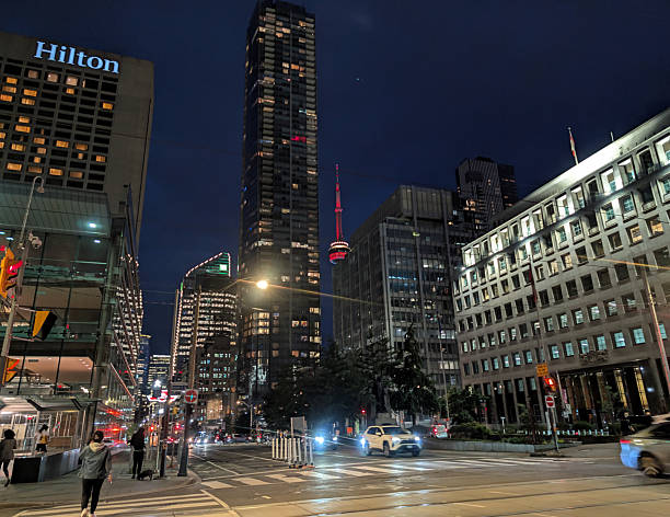 Toronto, Canada - August 26, 2025: Looking south on University Avenue at Queen Street West. Cultural venues, hotels, office buildings and residential towers line University Avenue . Pedestrians and traffic make their way through downtown on a summer evening.