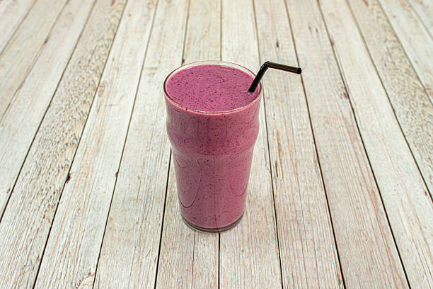 istock attractive red fruit juice with a straw served in a tall crystal glass 2241461261