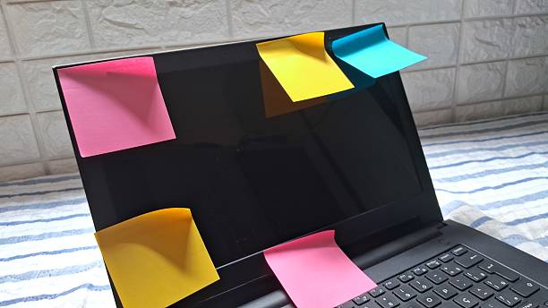 istock Colorful Post-its sticking to a laptop screen on a bed 2241462933