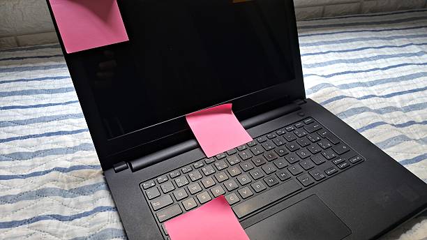 istock Colorful Post-its sticking to a laptop screen on a bed 2241462973