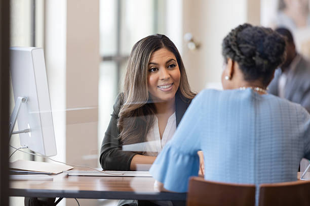 istock Businesswomen collaborating at desk with computer in modern office meeting 2241463096