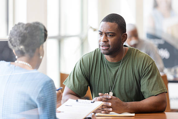 istock Veteran receives assistance during a meeting at a professional office. 2241463182