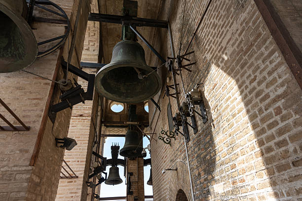 Interior of Seville Cathedral, Spain, showing a close-up view of majestic historic bells. Gothic architecture details and the unique atmosphere of one of the city's most iconic religious landmarks.